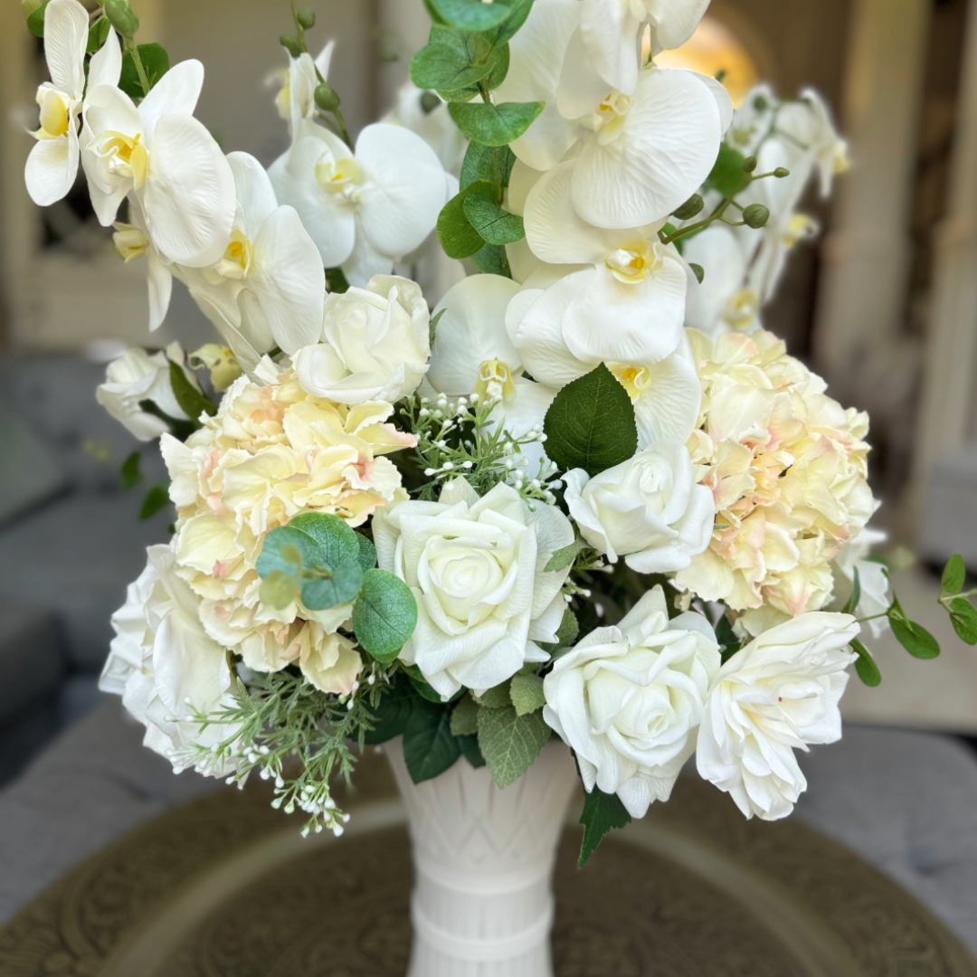 Luxury permanent floral arrangement featuring white orchids, roses, hydrangeas, and greenery in a white Bouquet Vase from the D&W Signature Collection.
