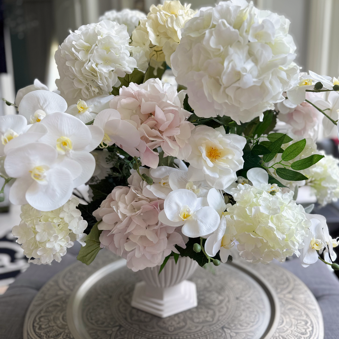 Crème Chantilly Grand Palais Platinum permanent floral arrangement with hydrangeas, orchids, and roses