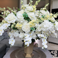 Crème Chantilly floral arrangement for the Grand Palais Platinum Collection, featuring lifelike white phalaenopsis orchids, ivory garden roses, hydrangeas, peonies, spray roses, and eucalyptus.