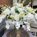 Crème Chantilly floral arrangement for the Grand Palais Platinum Collection, featuring lifelike white phalaenopsis orchids, ivory garden roses, hydrangeas, peonies, spray roses, and eucalyptus.