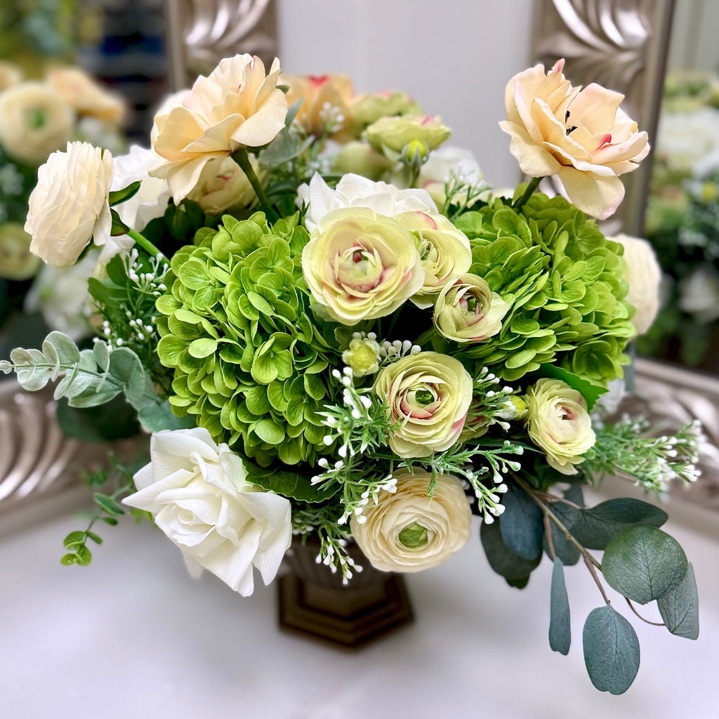 Signature Palais Bowl Duchess permanent floral arrangement with green hydrangeas, ivory and cream blooms in a Warm Bronze vessel.