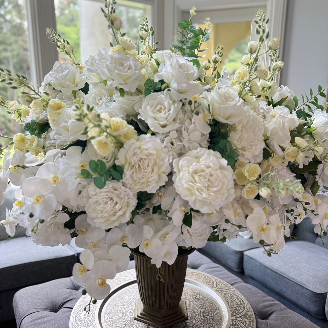 Crème Chantilly floral arrangement for the Grand Palais Platinum Collection displayed in the Grand Palais Bowl, featuring lifelike white phalaenopsis orchids, ivory garden roses, hydrangeas, peonies, spray roses, and eucalyptus.