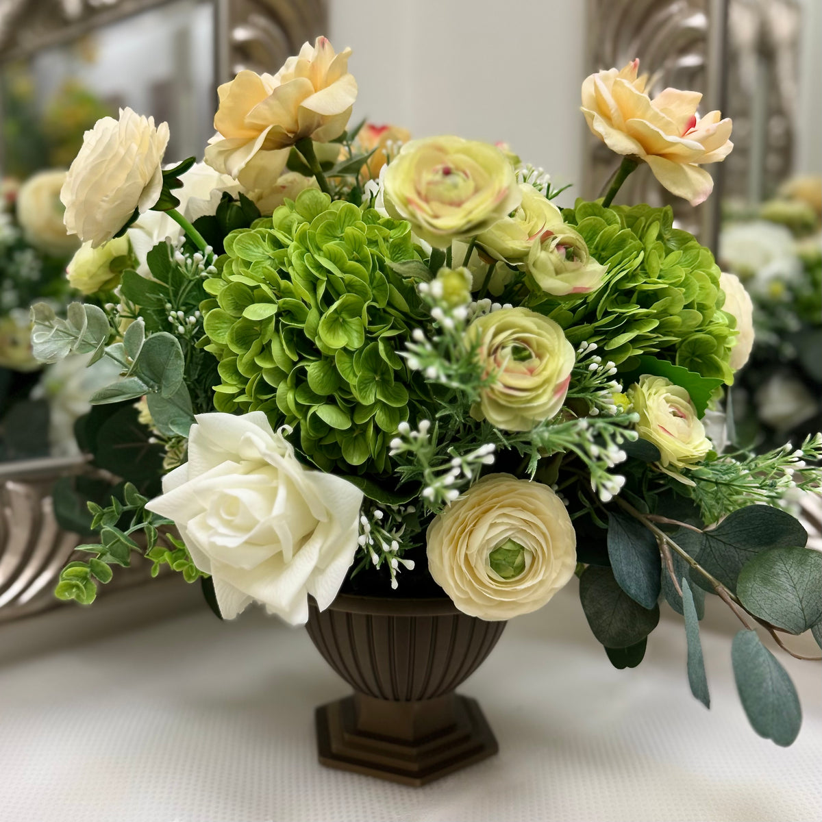 Signature Duchess permanent floral arrangement with green hydrangeas, ivory and cream blooms in a Warm Bronze Palais Bowl.