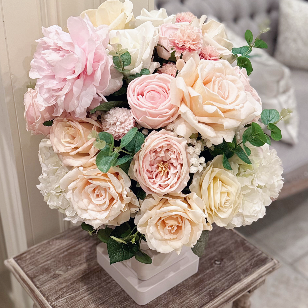 Close-up of the Atelier floral arrangement in the Bone White finish, Duchess size, Rosé Champagne palette, featuring lifelike blush peonies, garden roses, hydrangeas, and eucalyptus.