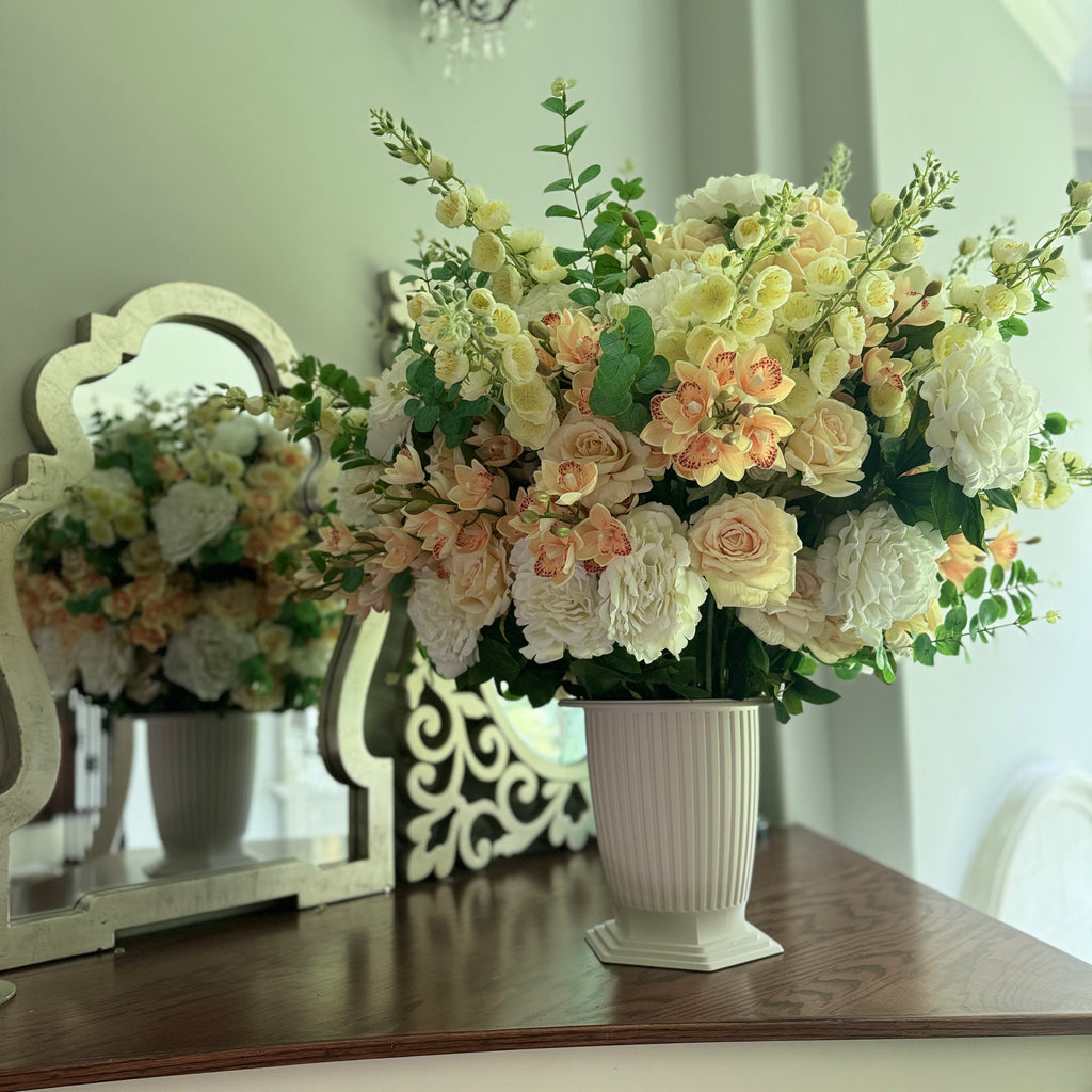 Grand Palais floral arrangement in the Bone White finish, Premium size, Peaches & Cream palette, styled on a staircase landing, featuring lifelike cream roses, peach cymbidium orchids, white peonies, blossom stems, and eucalyptus.