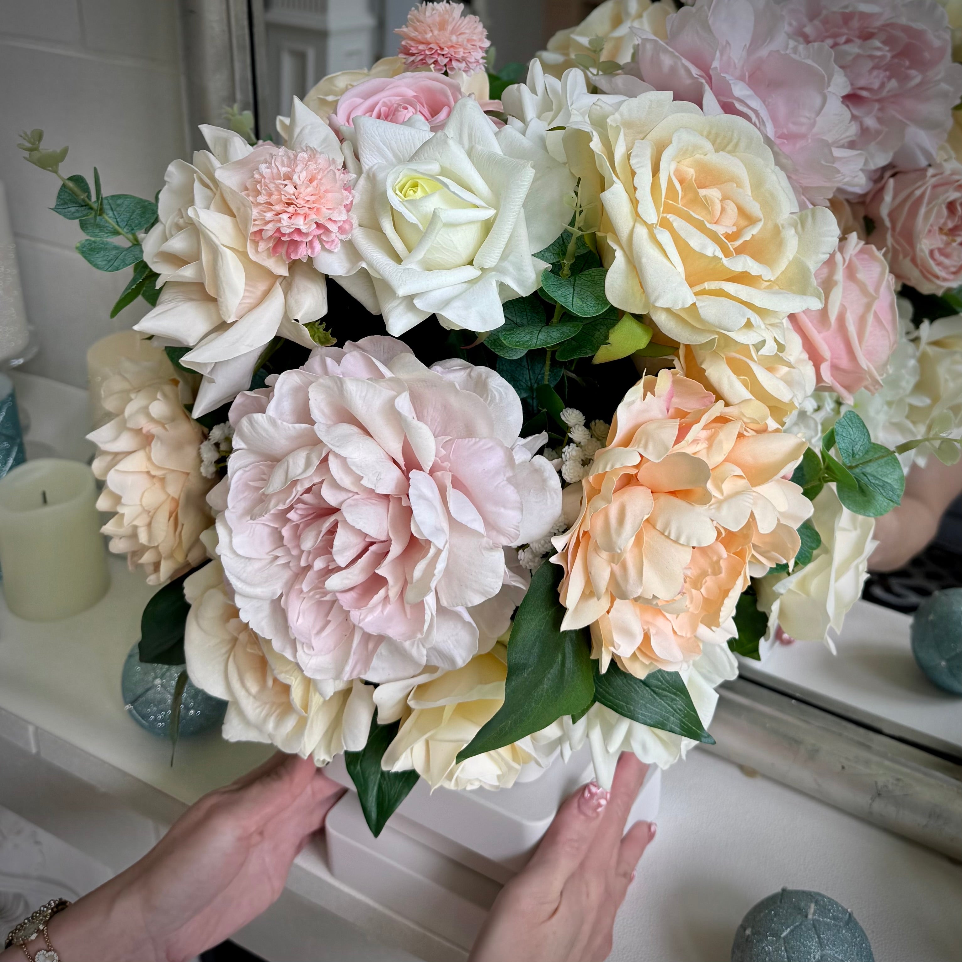 Atelier floral arrangement in the Bone White finish, Duchess size, Rosé Champagne palette, featuring lifelike blush peonies, cream and soft pink roses, peach blooms, and eucalyptus.