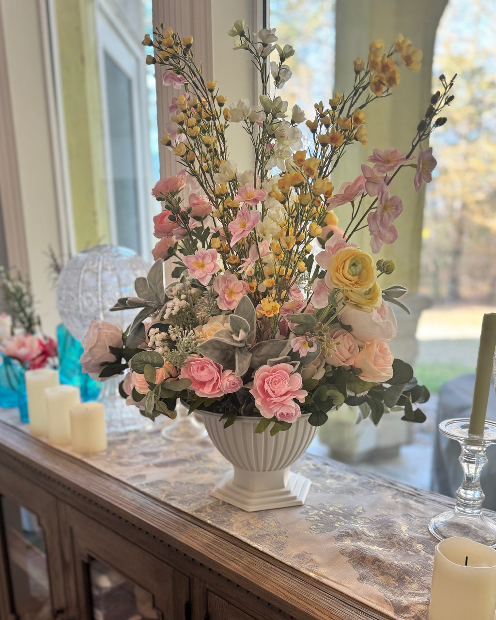 large floral centerpiece on sideboard table