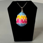 Painted Egg necklace displayed on jewelry bust
