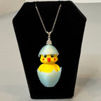 Chickadee Hatching Chick necklace displayed on jewelry bust