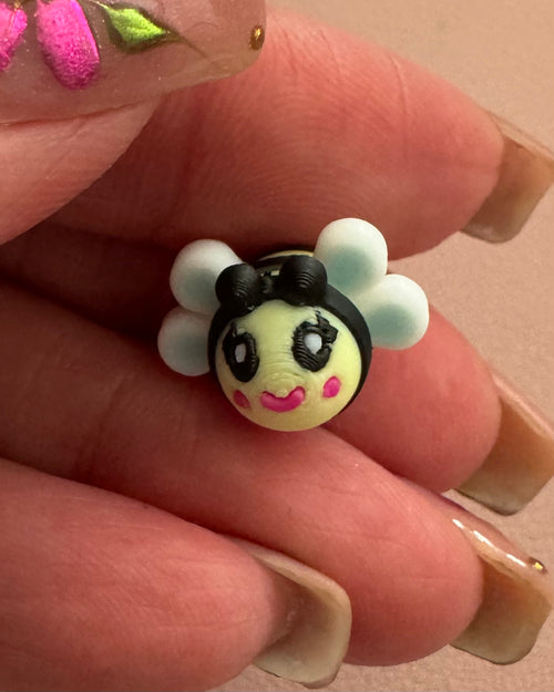 Front close-up of Bee Happy dangle earring featuring an artist-designed bee charm with white wings, hand-painted details, and sterling silver hook.