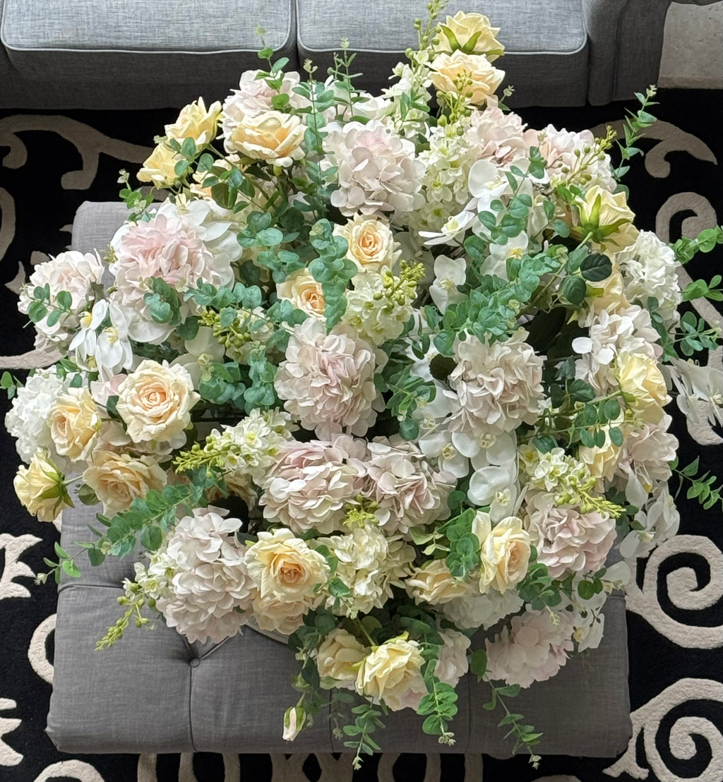Overhead view of a Grand Palais Platinum luxury permanent floral arrangement featuring blush hydrangeas, ivory roses, white orchids, eucalyptus greenery, and premium blooms