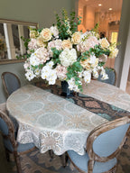 Grand Palais Platinum permanent floral arrangement displayed as a luxury dining table centerpiece featuring blush hydrangeas, ivory roses, white orchids, and eucalyptus greenery