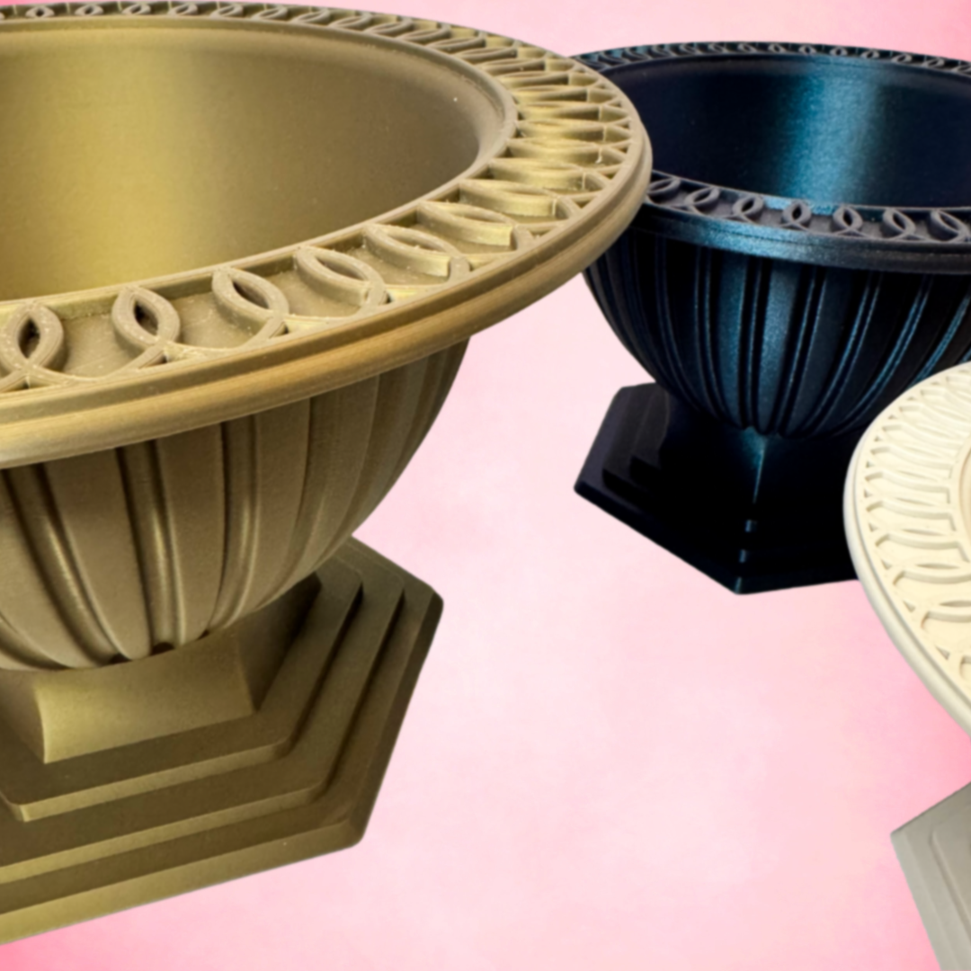 Decorative pots in gold, black, and beige on a pink background