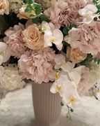 Grand Palais Platinum Rosé Champagne permanent floral arrangement featuring blush hydrangeas, cream roses, white orchids, and eucalyptus in Bone White fluted vase