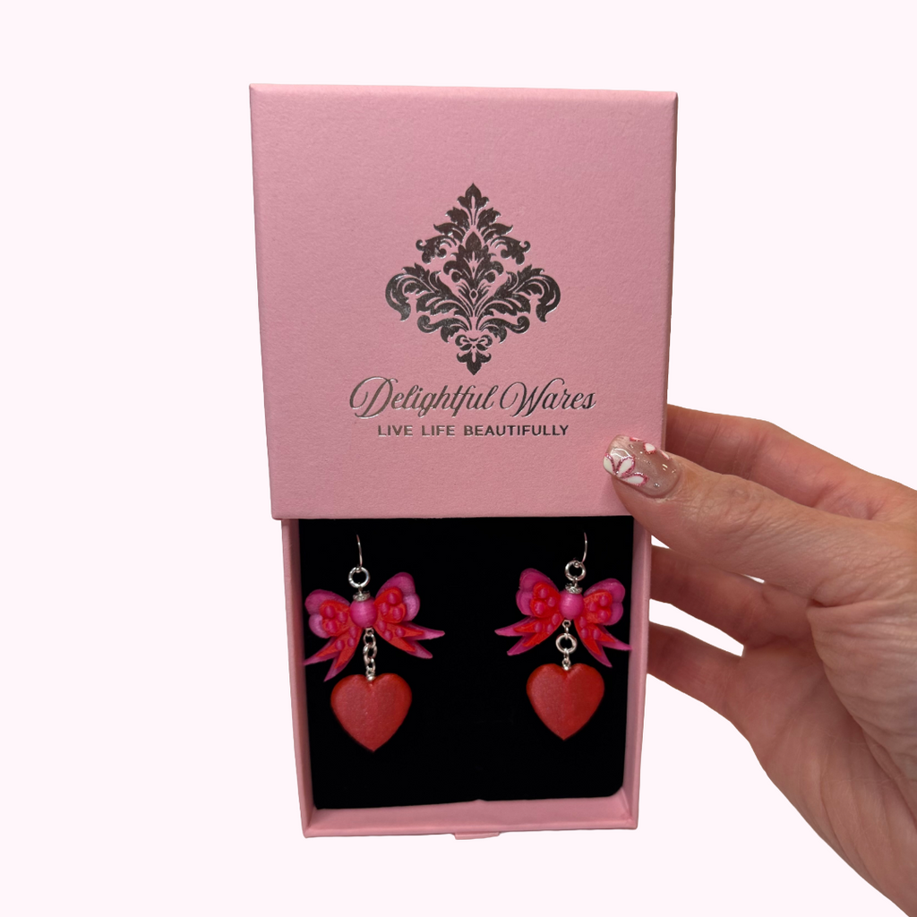 Bow & Heart Dangle Earrings presented in a signature Delightful Wares pink gift-ready jewelry box.