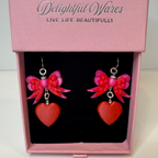 Bow & Heart Dangle Earrings presented in our Signature gift-ready jewelry box, featuring layered pink bows, red heart charms, and genuine 925 sterling silver hooks.