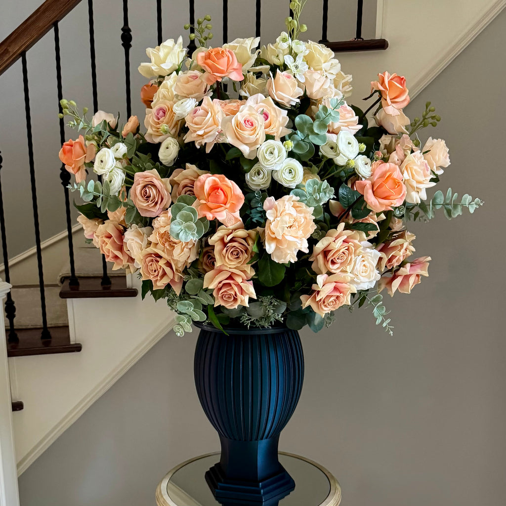 The Remembrance Column Vase permanent floral memorial arrangement in Peaches & Cream with peach, blush, ivory, and cream roses in an Onyx Shimmer sculptural vessel.