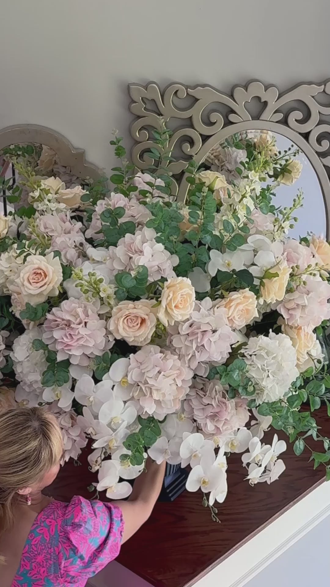 Video of the Grand Palais Platinum permanent floral arrangement in the Rosé Champagne palette being installed on a staircase, featuring blush hydrangeas, cream roses, white orchids, eucalyptus, and the Grand Palais Bowl in the Bone White finish.