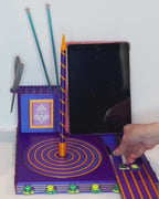 Frog Darn It! Luxury Yarn Spinner Organizer demonstrating the built-in phone and tablet stand, rotating yarn spinner, scissor holder, and crafting tool storage.